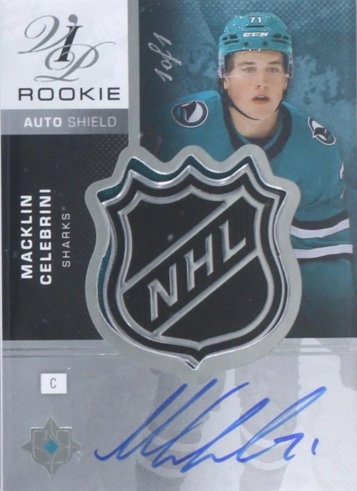 Macklin Celebrini VIP Rookie Shield Patch Auto 1 of 1, featuring a large NHL shield and blue autograph.