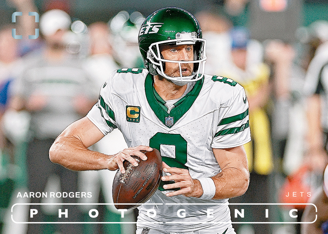 Aaron Rodgers in a white New York Jets number 8 uniform holding a football, pictured on a PhotoGenic card with his name and Jets identification.