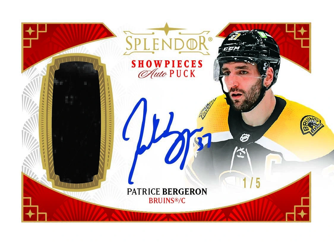 Patrice Bergeron beside a large puck window and blue autograph on a horizontal red-and-gold Showpieces card.