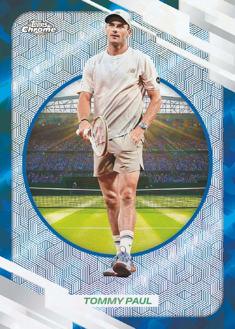 Tommy Paul’s blue Sapphire preview, with a pale shirt and shorts, racket at his side and a circular grass-court background.