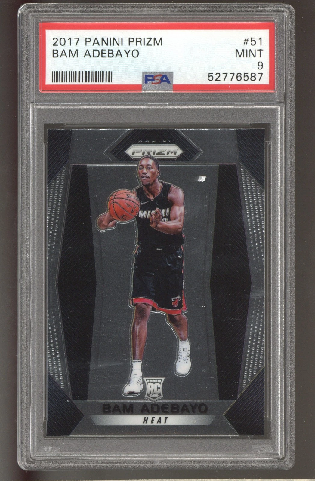 Bam Adebayo 2017–18 Panini Prizm #51 base rookie in a PSA 9 holder, passing in a black Miami uniform against a neutral silver background.